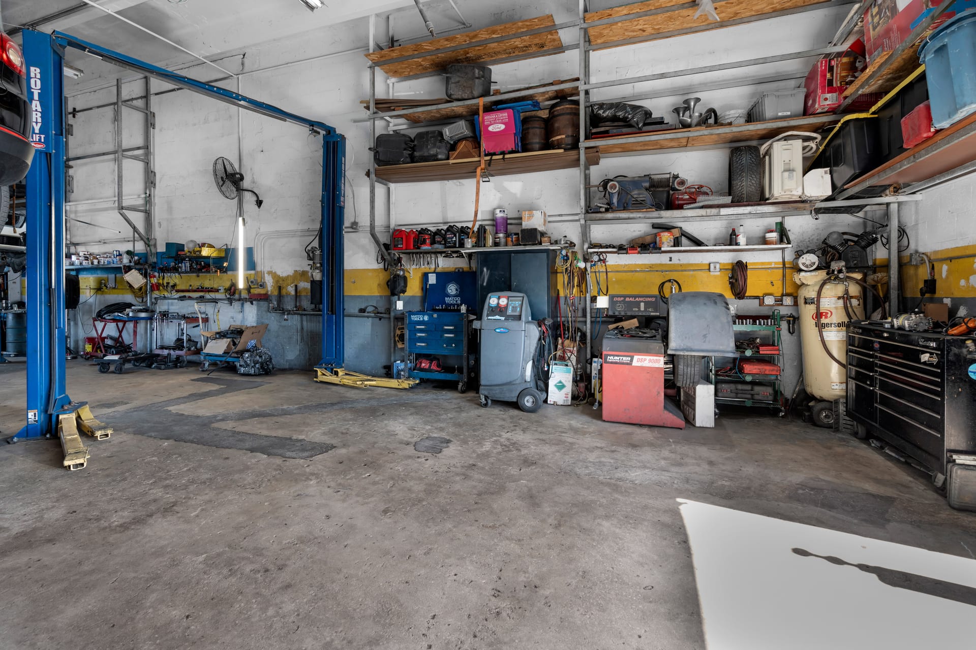 Service bay with a lift, tool wall and diagnostic equipment at Wires Auto Repair, Miami